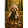 Plush dog toy in green dress, pink headband and bunny-shaped bag